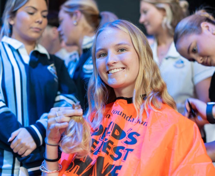 student holding cut hair