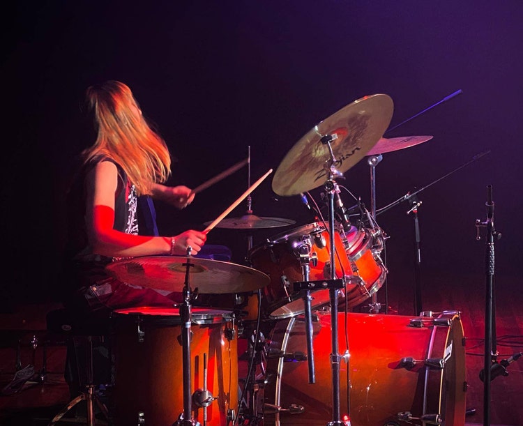 student playing the drums