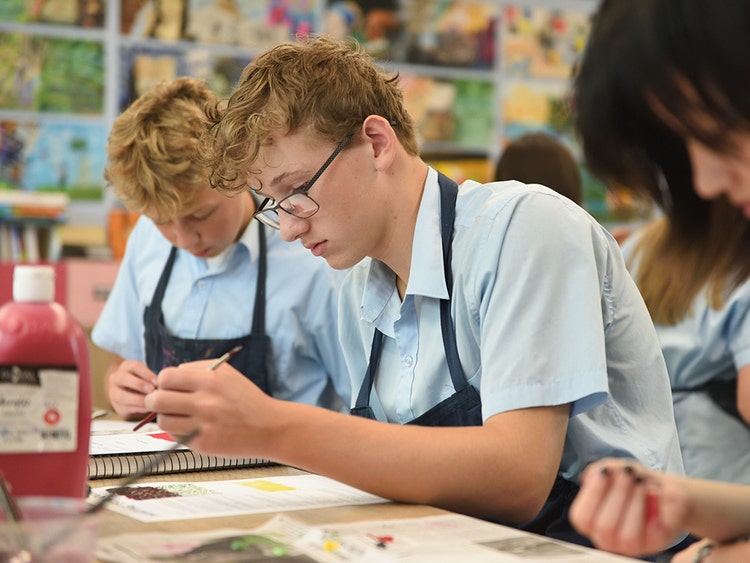 Student in classroom painting