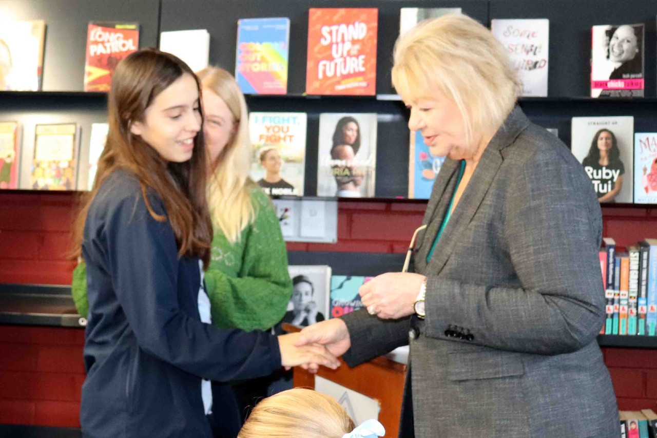 Students receiving badge