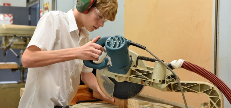 senior student using a drop saw