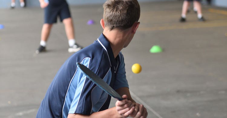student playing racket ball