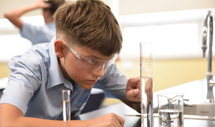 student completing science experiment