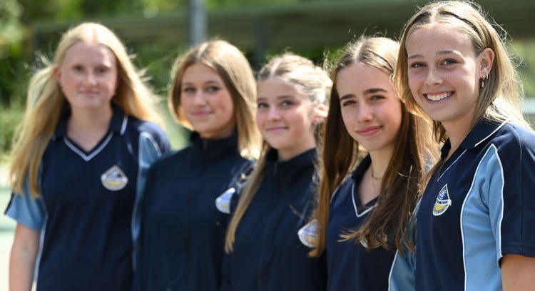 Smiling students in sports uniform